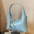 Glossy light blue hobo bag with pearl bow charm and heart pendant detail - Blue with Pendant