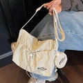 Creamy white nylon tote bag with drawstring pocket and small round charm pendant - Off White