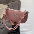 Pink minimalist crescent shoulder bag with silver bow accent and knotted strap detail - Pink