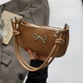 Minimalist caramel leather underarm bag with silver bow accent and knotted straps - Khaki