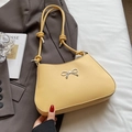 Pale yellow leather underarm bag with silver bow buckle and adjustable strap - Yellow