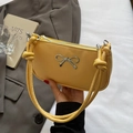 Bright yellow minimalist crescent bag with silver bow accent and knotted shoulder strap - Yellow