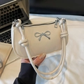 Chic beige half-moon shoulder bag with metallic bow detail and knotted handle strap - White