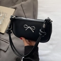 Minimalist black crescent bag with silver bow detail and knotted shoulder strap - Black