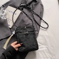 Black bucket bag with butterfly embroidery, rope strap and long tassel detail - Black