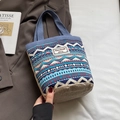 Ethnic style striped canvas bucket bag with blue woven handle and geometric patterns - Blue
