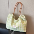Green and white plaid tote bag with orange rope handles and a minimal brand label - Green