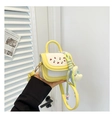 Detail of mini yellow and white crossbody bag with cherry embroidery and moon plush charm - Yellow with Pendant