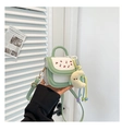 Detail of mint green cherry print handbag with cute moon plush charm and braided strap - Green with Charm