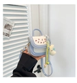 Close-up of a mini crossbody bag featuring cherry embroidery and a moon plush charm - Blue with Pendant