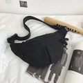 Minimalist black nylon crossbody sling bag with adjustable strap and buckle closure - Black