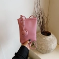 Pink lychee grain leather crossbody phone bag with woven ball charm detail - Pink