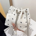 White pleated bucket bag with black bow print, silver chain strap and pearl accents - Off White