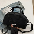 Minimalist black nylon crossbody tote bag with dual handles and adjustable shoulder strap - Black