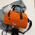 Minimalist orange nylon tote bag with navy straps and adjustable crossbody shoulder strap - Orange