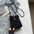 Black corduroy mini phone bag with white bow pattern and woven crossbody strap - Black