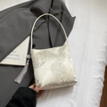 Cream satin bucket bag with oriental embroidery, floral prints and grey tassel detail - White With Tassel Pendant