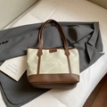 Cream canvas tote bag with brown leather trim and FASHION label in a lifestyle setting - No Pendant / Gray