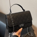Chic black quilted crossbody bag with leather handle and silver chain strap details - Black