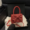 Borsa da sera rossa glitterata con grande fiocco e tracolla regolabile elegante - Rosso