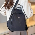 Versatile black nylon high-capacity backpack with adjustable straps and silver logo plate - Black