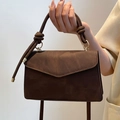 Brown vintage suede handbag featuring a unique rope knot handle and golden metal ring accents - Brown