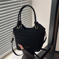Sac seau noir à motif léopard, détails dorés et poignée à nœud pour un style chic - Noir