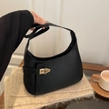 Minimalist black leather hobo shoulder bag with a gold twist lock and matte finish - Black