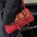 Dark red glossy underarm bag with metallic buckles and shoulder strap in street style - Burgundy