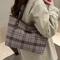 Brown checkered plaid tote bag with leather straps and rivets shown on model - Large Brown Grid