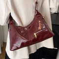 Glossy burgundy half-moon shoulder bag with gold zipper and patent leather finish - Red