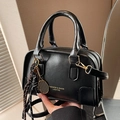 Black vintage Boston bag with tennis racket charm and woven tassel detail - With Charm / Black