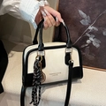 Chic black and white contrast leather Boston handbag with a sporty tennis racket charm - With Charm / White and Black