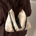 Chic beige leather backpack with adjustable black straps and silver metallic buckles - White and Black