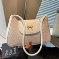 Chic cream-colored faux crocodile texture shoulder bag with silver bow accent - Off White