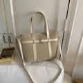Chic beige woven tote bag with adjustable shoulder strap and silver metal buckle accent - Beige