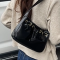 Minimalist black patent leather baguette bag with metallic eyelets and knot details - Black