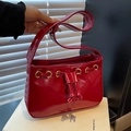 Glossy red patent leather shoulder bag with gold metal eyelets and drawstring detail - Red