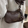 Brown vintage textured leather shoulder bag featuring an ornate abacus and bow charm - Coffee With Abacus & Bread Charm
