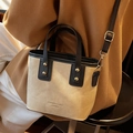 Beige and black canvas tote with rivets, adjustable strap, and fashion logo - White and Black