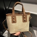 Beige canvas and brown leather mini bucket bag with adjustable strap and rivet detail - White and Brown