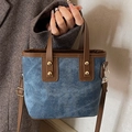 Blue denim crossbody bucket bag with brown leather trim and golden rivets - Blue