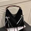 Versatile black tote backpack with brown leather straps and striped bow accents - Black