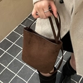 Dark brown suede bucket bag with slim handles, styled with a minimalist beige cashmere coat - Dark Brown