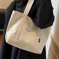 Borsa tote minimalista in tela beige con stampa Be Yourself indossata dal modello - Bianco Sporco