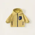 Hellgelbe Windjacke mit Kapuze für Jungen mit blauem Reißverschluss und Taschen - 80 / Gelbgrün