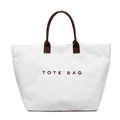 White corduroy tote bag with brown leather handles and printed TOTE BAG text - White