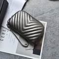 Deep grey-brown quilted leather clutch bag with golden zipper and metallic snake chain - Champagne