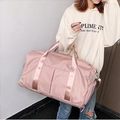 Pink waterproof Oxford cloth travel tote bag worn by a model in a minimalist setting - 16" / Pink