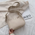 Minimalist beige hobo bag in half-moon shape with golden buckles on white fabric - Off White